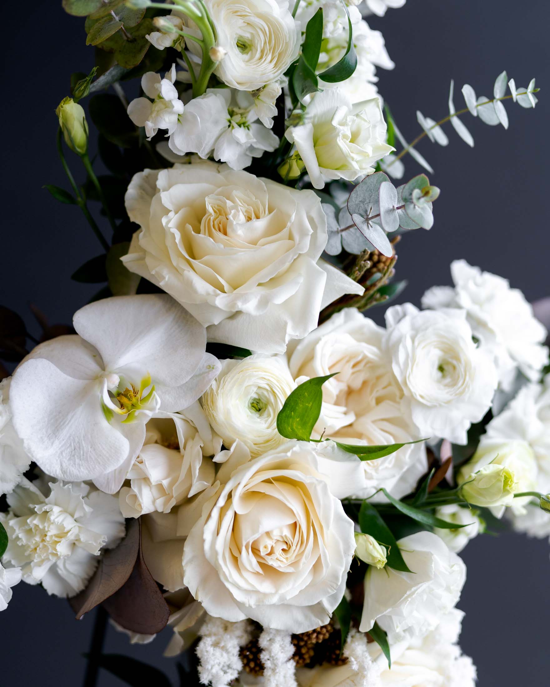 white sympathy cross funeral arrangement