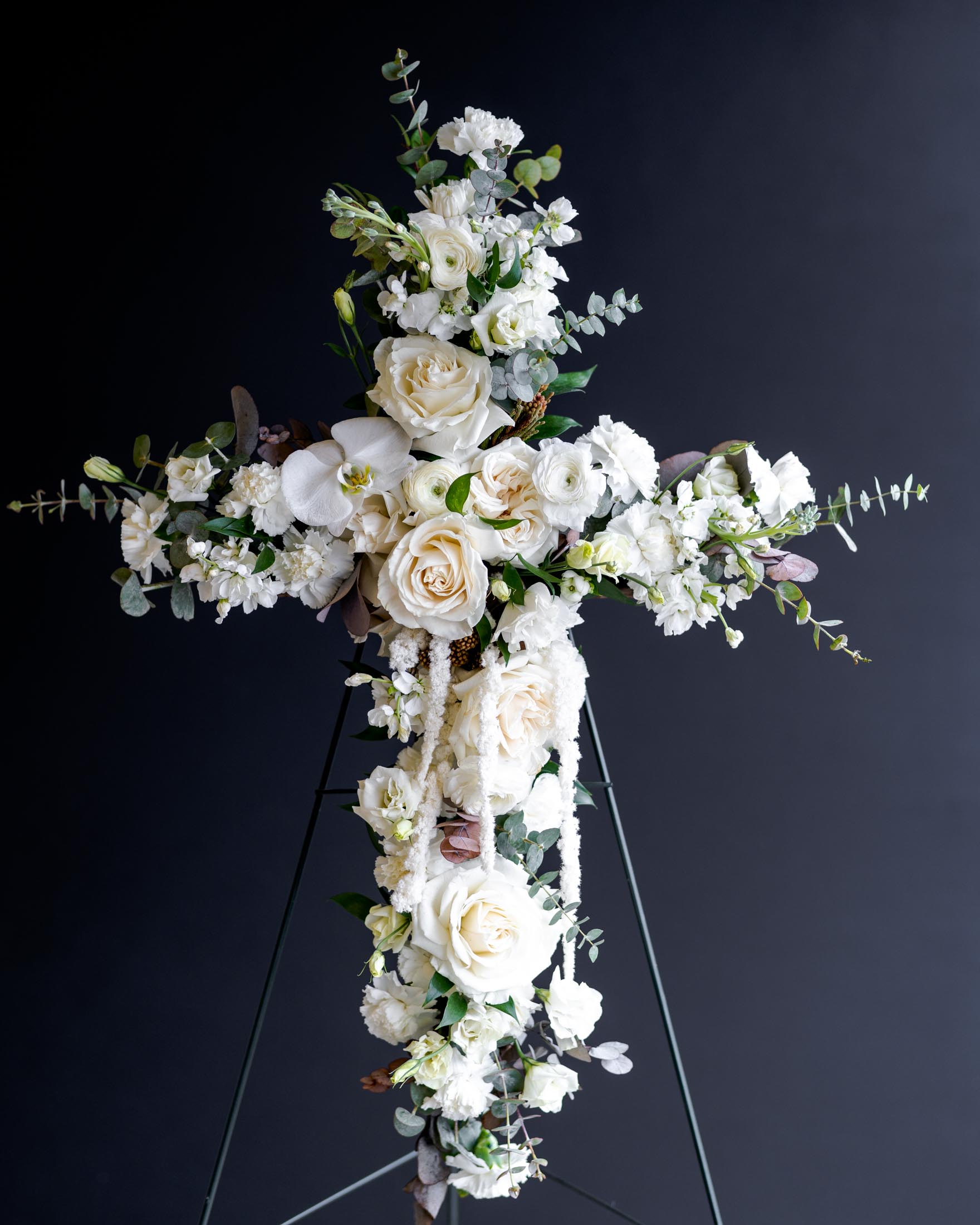 white sympathy cross funeral arrangement
